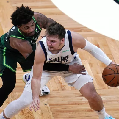 ﻿Dallas Mavericks guard Luka Doncic, right, is pressured by Boston Celtics guard Marcus Smart during the second half of an NBA basketball game Wednesday, March 31, 2021, in Boston. (AP Photo/Charles Krupa)