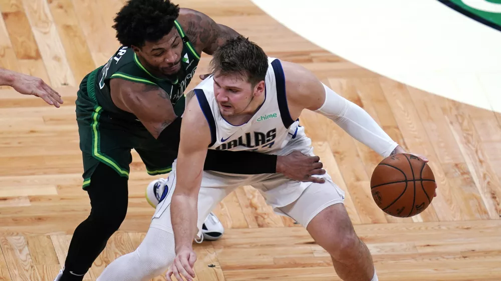 ﻿Dallas Mavericks guard Luka Doncic, right, is pressured by Boston Celtics guard Marcus Smart during the second half of an NBA basketball game Wednesday, March 31, 2021, in Boston. (AP Photo/Charles Krupa)