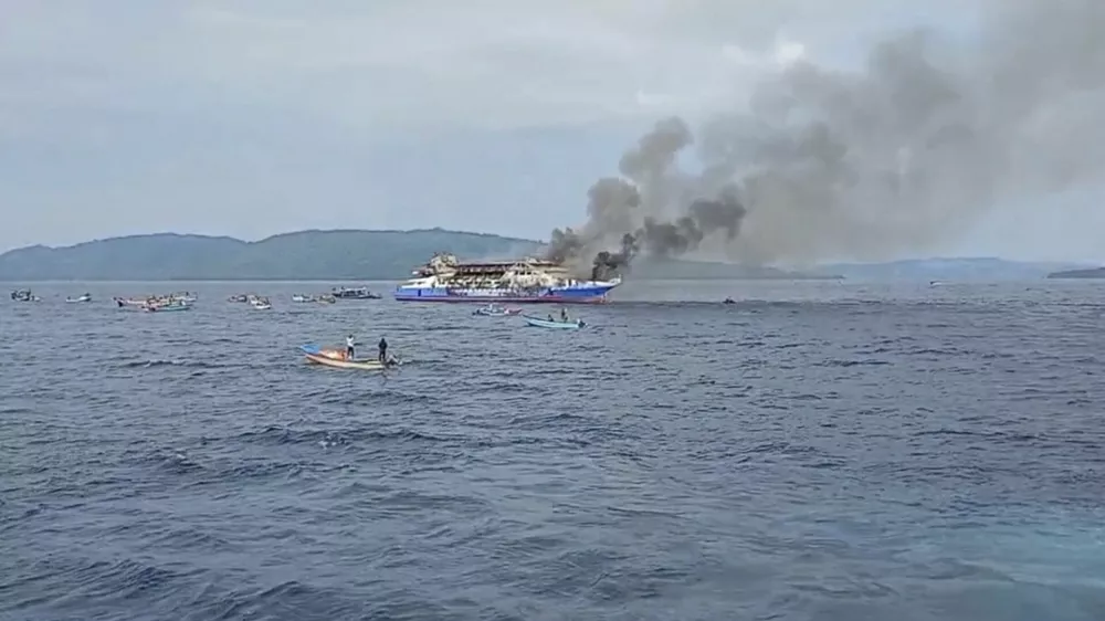 In this photo made from video released by the Indonesian National Search and Rescue Agency (BASARNAS), smoke billows from passenger ship KM Barcelona after it caught fire in the waters off Talise Island in North Sulawesi, Indonesia, Sunday, July 20, 2025. (BASARNAS via AP)