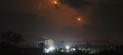 Illumination flares launched by the Israeli army are seen over Deir al-Balah in central Gaza Strip Monday, July 21, 2025. (AP Photo/Abdel Kareem Hana)
