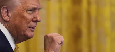 President Donald Trump raises his fist after speaking during a reception for Republican members of Congress in the East Room of the White House, Tuesday, July 22, 2025, in Washington. (AP Photo/Julia Demaree Nikhinson)