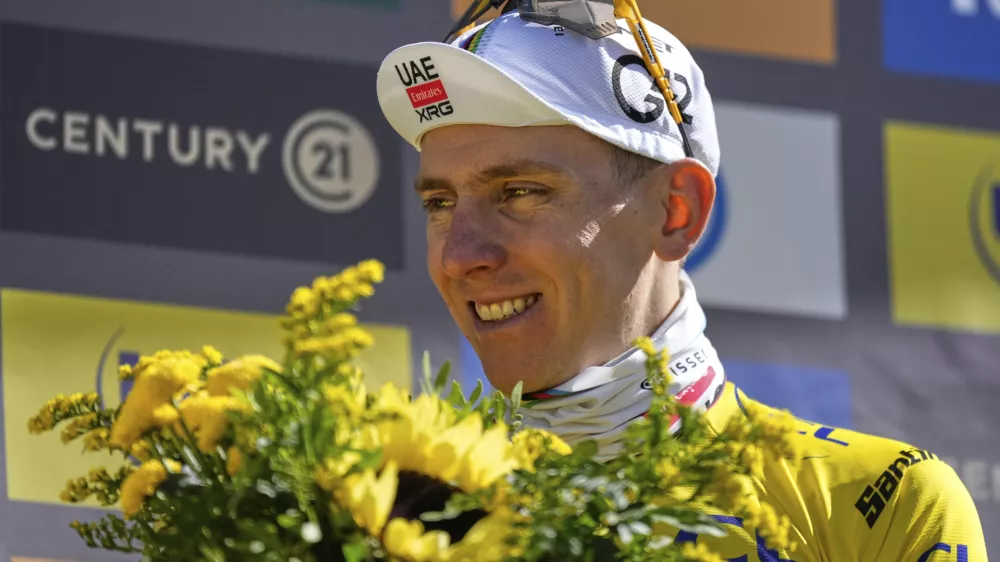Slovenia's Tadej Pogacar, wearing the overall leader's yellow jersey, celebrates on the podium after sixteenth stage of the Tour de France cycling race over 171.5 kilometers (106.6 miles) with start in Montpellier and finish on the Mont Ventoux, France, Tuesday, July 22, 2025. (AP Photo/Mosa'ab Elshamy)