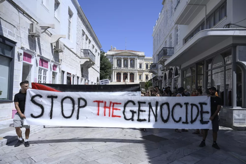 Protesters demonstrate against the departure of a cruise ship carrying Israeli tourists on the Aegean Sea island of Syros, Greece, Tuesday, July 22, 2025. (Nikos Panagiotopoulos/InTime News via AP)