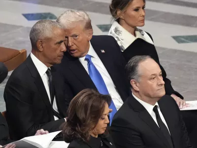 Former President Barack Obama talks with President-elect Donald Trump as Melania Trump listens and as Vice President Kamala Harris and second gentleman Doug Emhoff arrive, before the state funeral for former President Jimmy Carter at Washington National Cathedral in Washington, Thursday, Jan. 9, 2025. (AP Photo/Jacquelyn Martin)