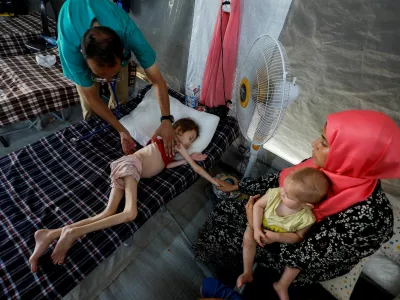 FILE PHOTO: A doctor checks Jana Ayad, a malnourished Palestinian girl, as she receives treatment at the International Medical Corps field hospital, amid the Israel-Hamas conflict, in Deir Al-Balah in the southern Gaza Strip, June 22, 2024. REUTERS/Mohammed Salem /File Photo