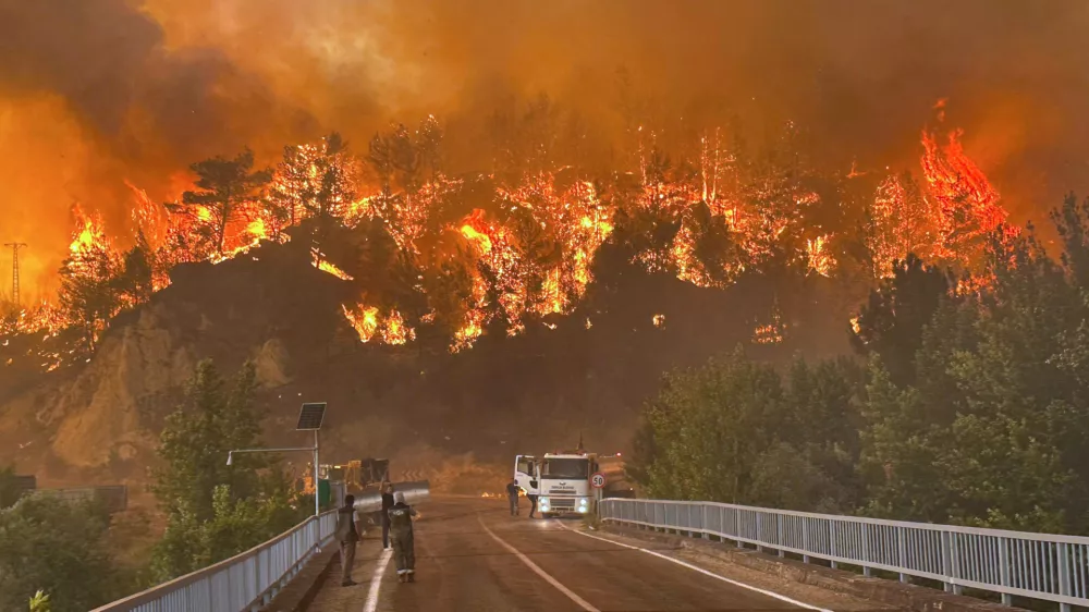 A wildfire rages across a forested area near Cavuslar village, in Karabuk district, northwest Turkey, Wednesday, July 23, 2025. (Ridvan Bostanci/IHA via AP)