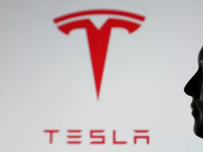 A-3D printed miniature model of Elon Musk's face and Tesla logo are seen in this illustration taken July 23, 2025. REUTERS/Dado Ruvic/Illustration