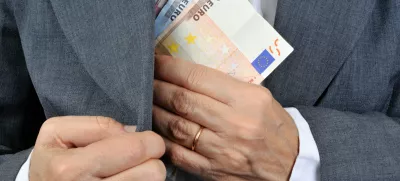 man putting money in his pocket