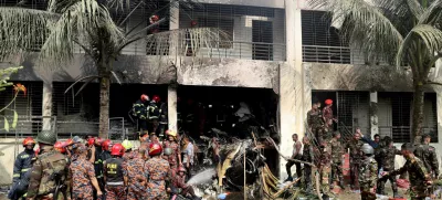FILE PHOTO: Firefighters and soldiers work next to the wreckage of an air force training aircraft after it crashed into Milestone College campus, in Dhaka, Bangladesh, July 21, 2025. REUTERS/Stringer/File Photo