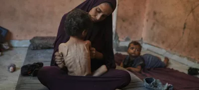 Naima Abu Ful poses for a photo with her 2-year-old malnourished child, Yazan, at their home in the Shati refugee camp in Gaza City, Wednesday, July 23, 2025. (AP Photo/Jehad Alshrafi)