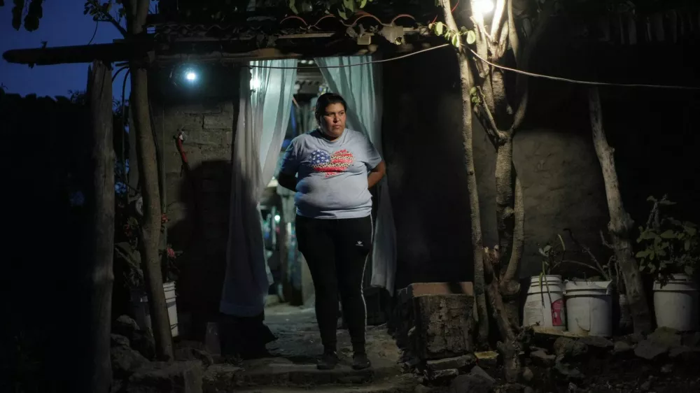 Sonia Coria, a Mexican migrant who fled cartel violence in her hometown with her family and sought refuge in Arizona, U.S., before voluntarily returning to Mexico, stands outside her home in Uruapan, Michoacan state, Mexico, July 18, 2025. REUTERS/Ivan Arias