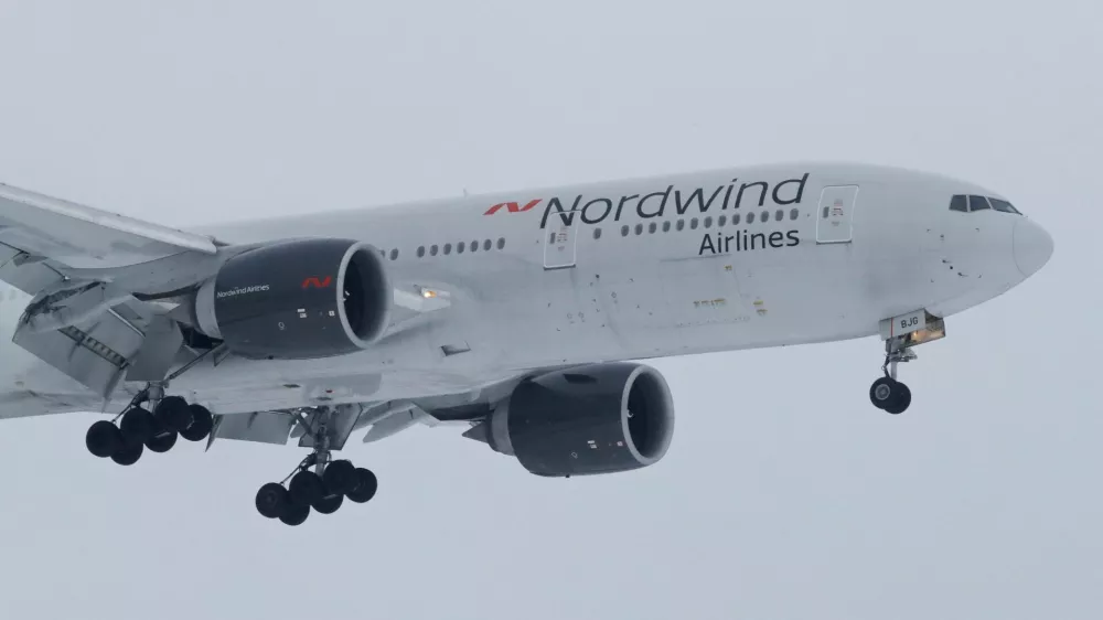 FILE PHOTO: A 777-200ER plane owned by Russia's Nordwind Airlines descends before landing and completing a direct flight from the Venezuelan capital of Caracas at Vnukovo International Airport outside Moscow, Russia January 31, 2019. REUTERS/Tatyana Makeyeva/File Photo