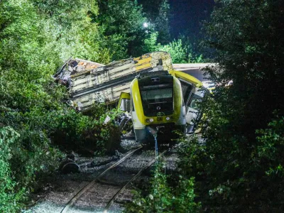 Wagons of a derailed regional passenger train lie on a railroad line near Riedlingen, Germany, early Monday, July 28, 2025. (dpa via AP)