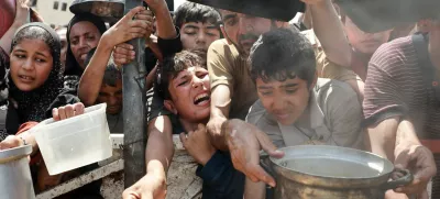Palestinians wait to receive food from a charity kitchen, amid a hunger crisis, in Gaza City, July 28, 2025. REUTERS/Khamis Al-Rifi