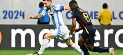 Jul 4, 2024; Houston, TX, USA; Argentina's striker Lionel Messi (10) controls the ball as Ecuador's midfielder Carlos Gruezo (8) defends during the first half at NRG Stadium. Mandatory Credit: Maria Lysaker-USA TODAY Sports