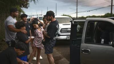Ewa Beach residents Carlo Salas and CJ Jasper, with their families, are evacuated at the side of Kunia Road to escape the tsunami threat Kapolei, Oahu, Hawaii, Tuesday, July 29, 2025. (AP photo/Michelle Bir)