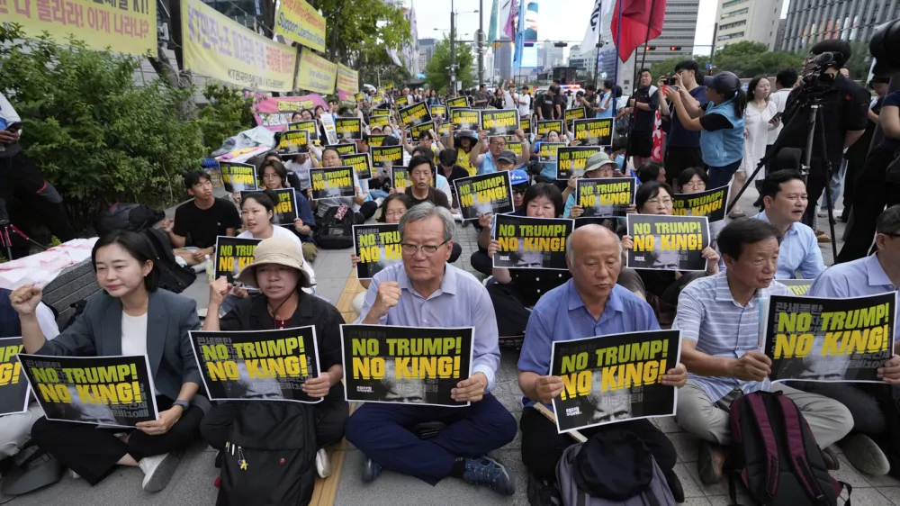 South Korean protesters stage a rally against U.S. President Donald Trump's tariffs policy on South Korea, near the U.S. Embassy in Seoul, South Korea, Wednesday, July 30, 2025. (AP Photo/Ahn Young-joon)