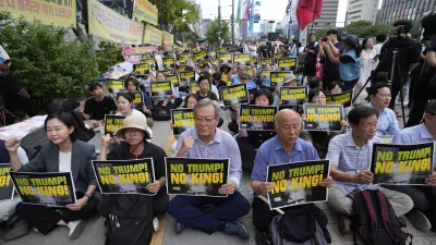 South Korean protesters stage a rally against U.S. President Donald Trump's tariffs policy on South Korea, near the U.S. Embassy in Seoul, South Korea, Wednesday, July 30, 2025. (AP Photo/Ahn Young-joon)