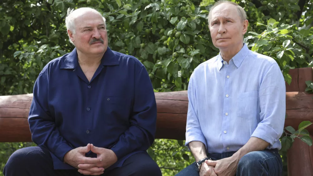 Russian President Vladimir Putin, right, and Belarusian President Alexander Lukashenko sit on a bench during their visit to the Smolensky Skete of Valaam Monastery at Valaam island in Ladoga lake, Republic of Karelia, Russia, Friday, Aug. 1, 2025. (Gavriil Grigorov, Sputnik, Kremlin Pool Photo via AP)