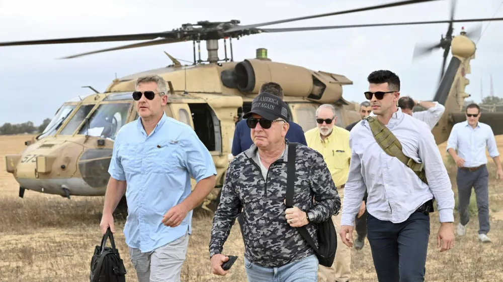 This handout photo from US Embassy Jerusalem shows White House special envoy Steve Witkoff, center, visiting a food distribution site run by the Gaza Humanitarian Foundation, a U.S.-backed organization approved by Israel, in the Gaza Strip Friday, Aug. 1, 2025. (David Azaguri/US Embassy Jerusalem via AP)