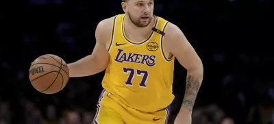 Los Angeles Lakers guard Luka Doncic (77) dribbles up the court during the first half of Game 2 of an NBA first-round playoff series against the Minnesota Timberwolves in Los Angeles, Tuesday, April 22, 2025. (AP Photo/Eric Thayer)