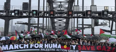 Thousands of protesters walk across the Sydney Harbour Bridge during the Palestine Action Group's March for Humanity in Sydney, Sunday, Aug. 3, 2025. (Dean Lewins/AAP Image via AP)