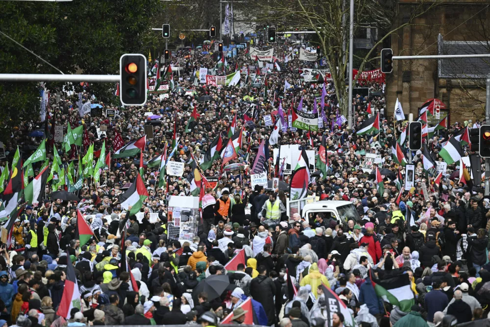 Thousands of protesters line streets ahead of a march across the Sydney Harbour Bridge during the Palestine Action Group's March for Humanity in Sydney, Sunday, August 3, 2025. (Dean Lewins/AAP Image via AP)