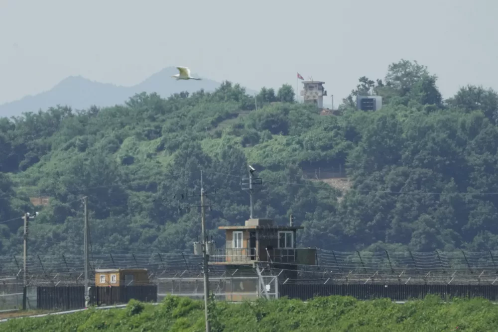 A North Korean military guard post, loudspeaker, top right, and South Korean military guard post, bottom, are seen from Paju, South Korea, near the border with North Korea, Monday, Aug. 4, 2025. (AP Photo/Ahn Young-joon)