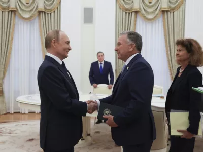 Russian President Vladimir Putin, left, and U.S. President Donald Trump's special envoy Steve Witkoff, right, shake hands during their meeting at the Kremlin in Moscow, Russia, Wednesday, Aug. 6, 2025. (Gavriil Grigorov, Sputnik, Kremlin Pool Photo via AP)