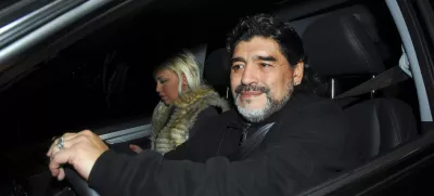 Former Argentine soccer star and coach Diego Maradona drives his car along with his girlfriend Veronica Ojeda in Buenos Aires July 8, 2011. Maradona and his girlfriend escaped serious injury on Monday when his car was involved in a collision with a bus near his Buenos Aires home, local media and officials said. Picture taken July 8, 2011. REUTERS/Enrique Garcia Medina (ARGENTINA - Tags: DISASTER PROFILE SPORT SOCCER)