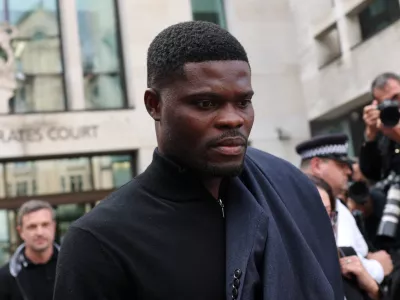 Former Arsenal player Thomas Partey, who has been charged with five counts of rape and one count of sexual assault, walks outside Westminster Magistrates' Court, in London, Britain, August 5, 2025. REUTERS/Hannah McKay