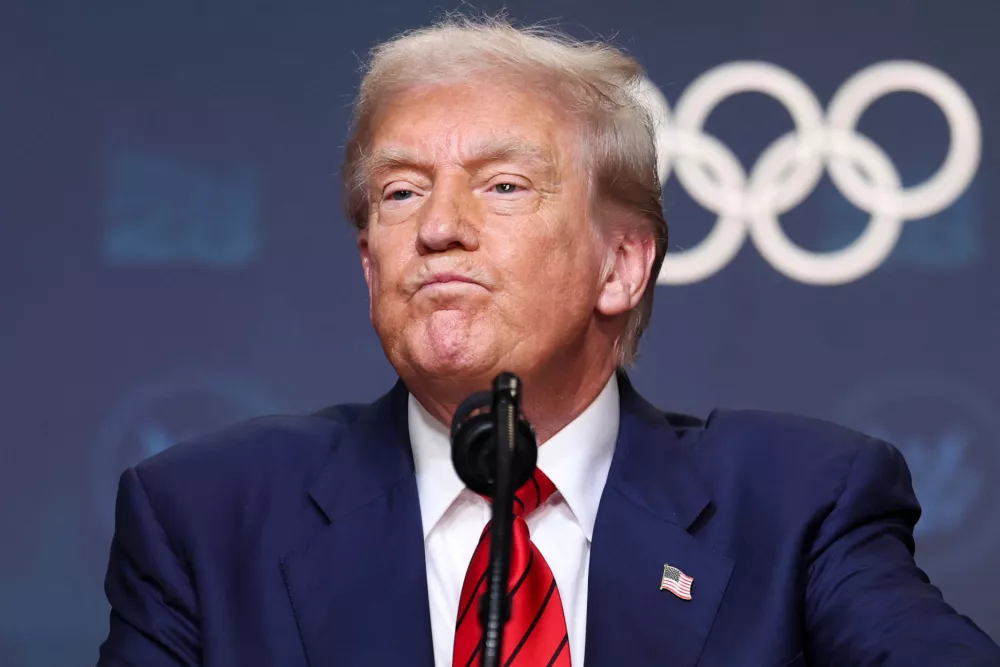 U.S. President Donald Trump reacts after signing an executive order to create a White House Olympics task force to handle security and other issues related to the LA 2028 summer Olympics in the South Court Auditorium on the White House campus in Washington, D.C., U.S., August 5, 2025. REUTERS/Jonathan Ernst