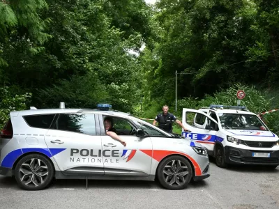 Police France, francija, policija, french police, francoska policijaPolice cars are parked in front of a cordoned-off area, near a sports field where a 32-year-old man was found dead with his throat slit and gutted, in Pont-de-Metz on August 4, 2025. The victim had stab wounds to the neck and back and has been found by a walker in a cross position, police told AFP.,Image: 1027676326, License: Rights-managed, Restrictions:, Model Release: no