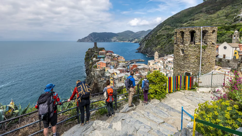 Vernazza, Italy - May 2, 2019 People tourists ingoing the view at Vernazza village and Cinque Terre coastal area from the Trial Sentiero Azzuro. Liguria, Italy.
