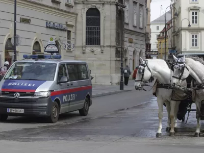 A police van drives past Fiaker horses at St. Stephen's cathedral in Vienna, Austria, Wednesday, Mar 15, 2023. Austrian police are warning of a possible "Islamist-motivated attack" targeting churches in Vienna. They cited undisclosed information the country's intelligence service had received. (AP Photo/Heinz-Peter Bader)