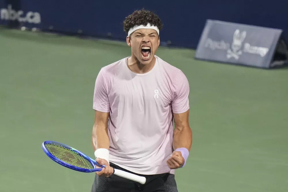 Ben Shelton, of the United States, reacts after winning match point to defeat Karen Khachanov, of Russia, and win the men's final at the National Bank Open tennis tournament in Toronto, Thursday, Aug. 7, 2025. (Chris Young/The Canadian Press via AP)