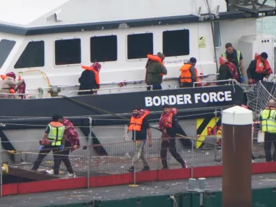 07 August 2025, United Kingdom, Dover: A group of people thought to be migrants are brought in to the Border Force compound in Dover, Kent, from a Border Force vessel following a small boat incident in the Channel. Photo: Gareth Fuller/PA Wire/dpa