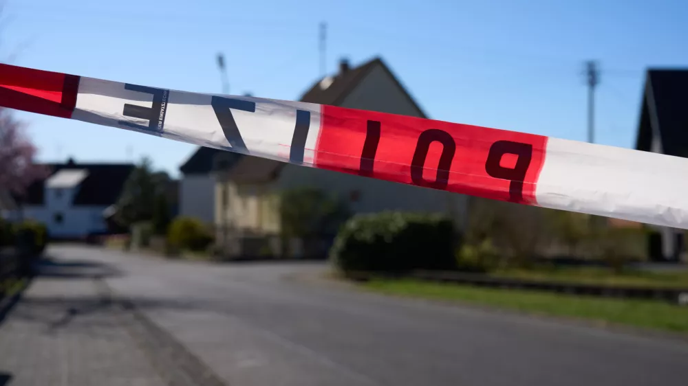 07 April 2025, Weitefeld: A road is cordoned off with police tape as the investigation into the violent attack that left three family members dead in the Westerwald continues. Authorities are working to determine the circumstances surrounding the incident. Photo: Thomas Frey/dpa