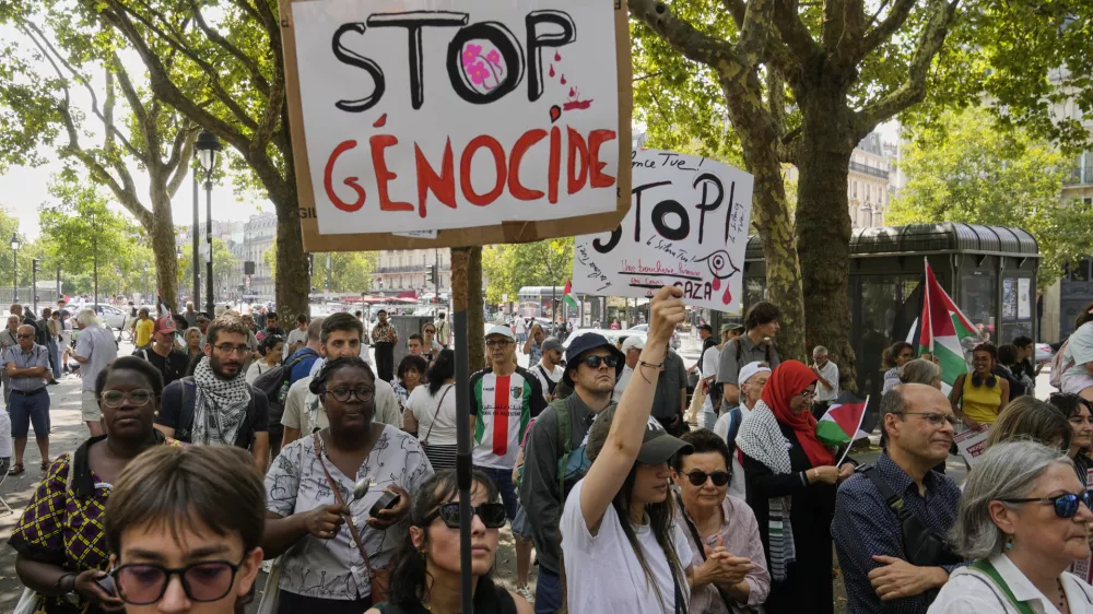 Protesters hold placards during a gathering in support of the Palestinian people in the Gaza Strip, at Bastille square in Paris, Saturday, Aug. 9, 2025. (AP Photo/Michel Euler)