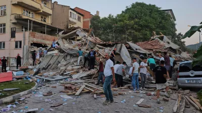 People remove the wreckage of a collapsed building following an earthquake in Sindirgi, northwest Turkey, Sunday, Aug. 10, 2025. (Bahadir Demirceviren/IHA via AP)