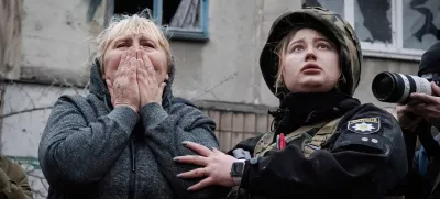 14 April 2023, Ukraine, Sloviansk: A resident reacts next to a policewoman while they await for the rescue team to reach for her family members in the rubble in Sloviansk. Russian troops attacked eastern Ukrainian city Sloviansk on eastern Orthodox great Friday, causing at least 8 dead and 21 injured, including children and many buildings destroyed. Photo: Ashley Chan/SOPA Images via ZUMA Press Wire/dpa