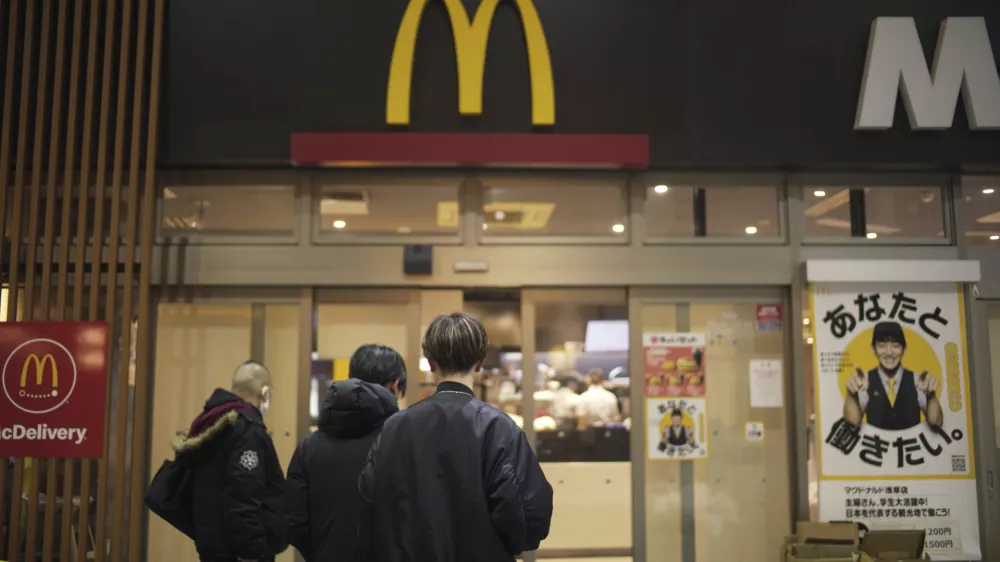 FILE - People stands outside a McDonald's store in Tokyo, March 15, 2024. (AP Photo/Hiro Komae, File)