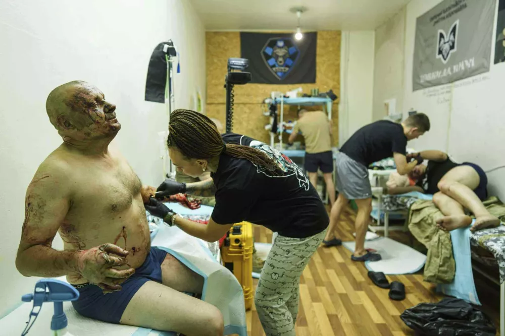 Medics of Da Vinci Wolves Battalion treat Ukrainian soldiers injured during fighting with Russian forces on the front line at stabilization point on Pokrovsk direction, Ukraine, on Monday, Aug. 11, 2025. (AP Photo/Evgeniy Maloletka)
