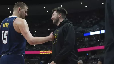 Denver Nuggets center Nikola Jokic, left, greets Los Angeles Lakers guard Luka Doncic, right, in the first half of an NBA basketball game Friday, March 14, 2025, in Denver. (AP Photo/David Zalubowski)