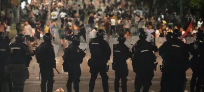 Serbian gendarmerie officers guard the street during an anti-government protest near Serbian Progressive Party office in Belgrade, Serbia, Thursday, Aug. 14, 2025. (AP Photo/Darko Vojinovic)