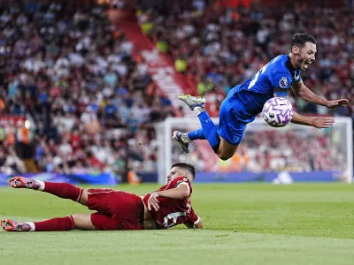 Liverpool's Milos Kerkez challenges Bournemouth's Adam Smith, top, during the English Premier League soccer match between Liverpool and Bournemouth at Anfield, Liverpool, England, Friday Aug. 15, 2025. (Peter Byrne/PA via AP)