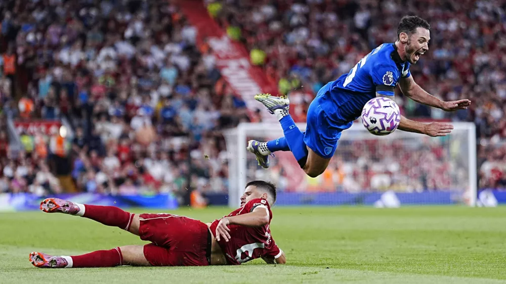 Liverpool's Milos Kerkez challenges Bournemouth's Adam Smith, top, during the English Premier League soccer match between Liverpool and Bournemouth at Anfield, Liverpool, England, Friday Aug. 15, 2025. (Peter Byrne/PA via AP)
