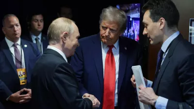 HANDOUT - 15 August 2025, US, Alaska: US President Donald Trump (C) and Russian President Vladimir Putin (L) speak privately ahead of their joint press conference following their meeting in Alaska. Photo: -/Kremlin/dpa - ATTENTION: editorial use only and only if the credit mentioned above is referenced in full