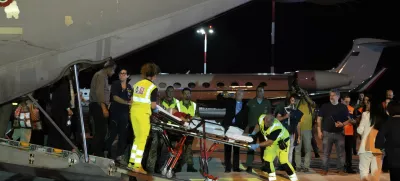 Palestinian children and their families evacuated from Gaza arrive at Rome's Ciampino military airport, Thursday, Aug. 14, 2025. (AP Photo/Gregorio Borgia)