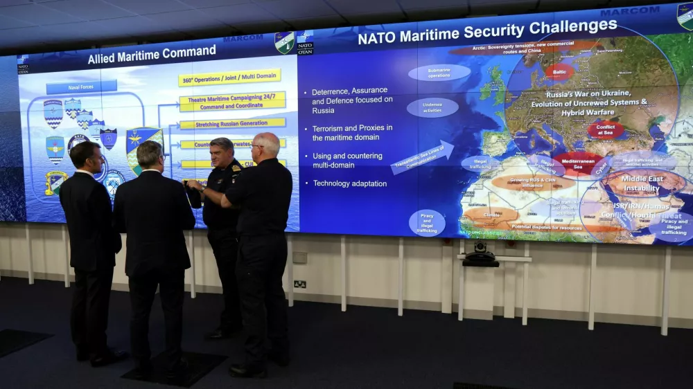 France's President Emmanuel Macron and Britain's Prime Minister Keir Starmer listen to a NATO military officer during a Coalition of the Willing meeting at a military base at Northwood Headquarters in north-west London, Britain, on July 10, 2025. LUDOVIC MARIN/Pool via REUTERS